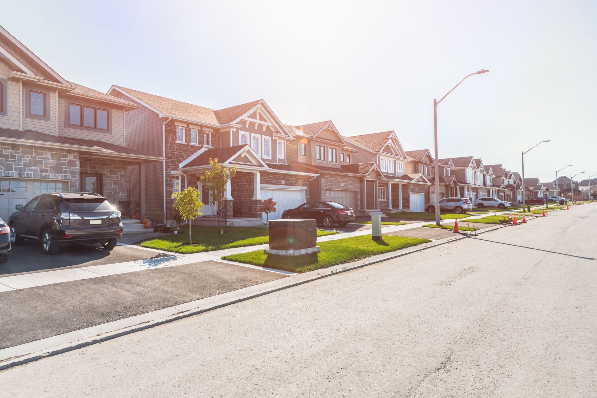 New houses along a street in a housing development on a sunny autumn day