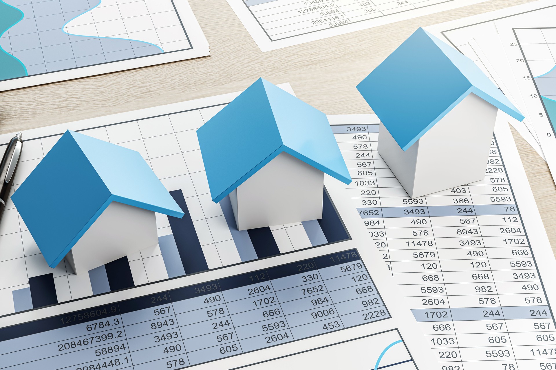 Real estate market analysis concept with miniature house models on charts and spreadsheets on light wooden background. 3D Rendering